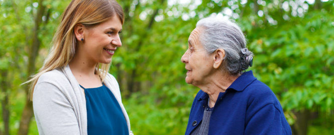 Senior woman outside with caregiver