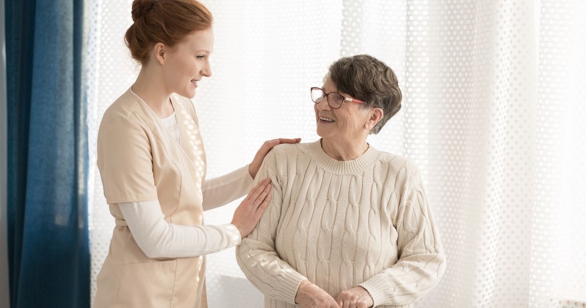 A senior woman receives home care assistance.