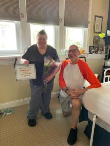 Kimberly, our Caregiver of the Month for June 2022, with a client.