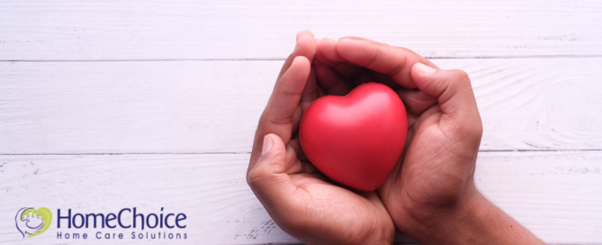 Hands holding a heart shape represent the care and support that those caring for seniors at home need.