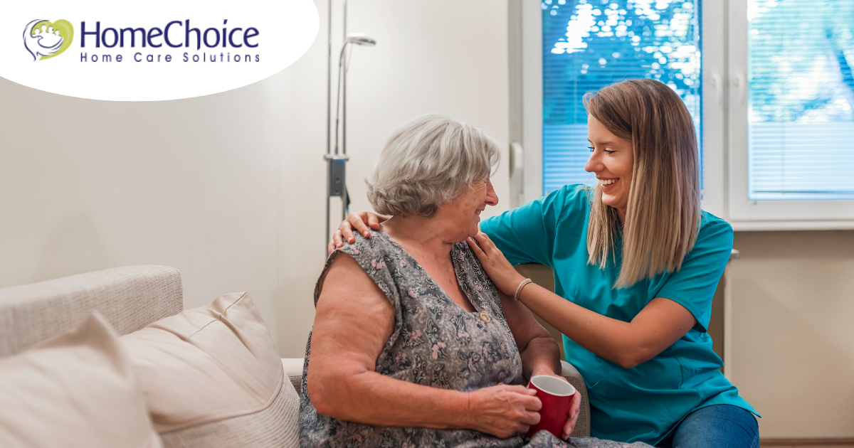 A home care provider compassionately tends to a senior client in their home.