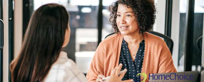 A woman interviews another woman for a caregiver job position.