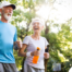A senior couple enjoys walking outdoors, one of many activities for seniors that can help them stay healthy.