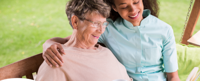 Professional caregivers like this one who is reading a book with a senior client can help them stay mentally active and engaged.