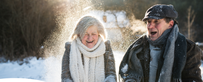 As a result of good winter safety practices, an elderly couple can enjoy time outside in the snow.