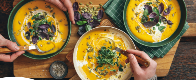 Pumpkin soup like the one in these bowls can be a great choice for a winter food for older adults.