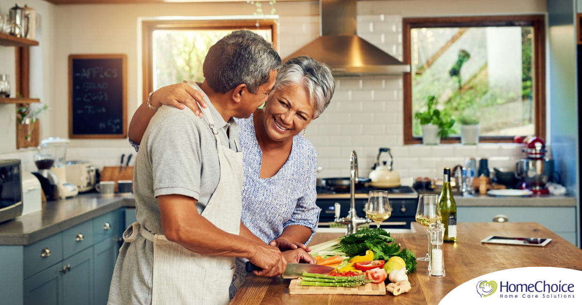 A senior couple enjoys cooking a healthy meal together, representing National Nutrition Month.