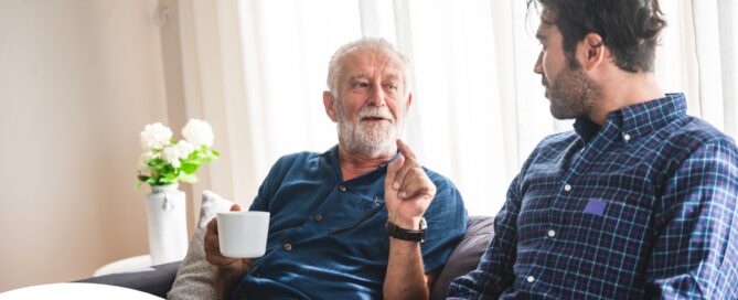 A son talks with an older parent representing the kind of communication needed to tell how aging parents are doing.