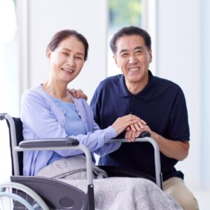 Senior Home Care in Chapel Hill, NC (1) A cheerful caregiver kneels next to an elderly woman in a wheel chair who is smiling. Senior Home Care in Chapel Hill, NC