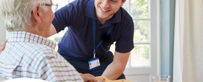 Professional caregiving involves helping clients with iADLs and ADLs as demonstrated by this caregiver helping a client by bringing a meal.