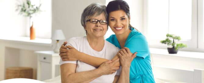 A caregiver hugs an older client, representing how a trustworthy caregiver cares for clients.
