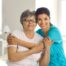A caregiver hugs an older client, representing how a trustworthy caregiver cares for clients.
