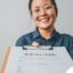 A woman happily hands in a resume, representing a successfully written caregiver resume.