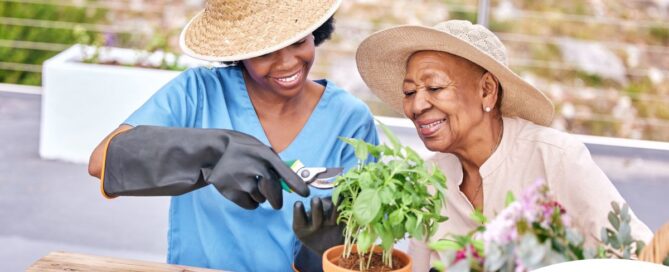 Caregiver and Senior gardening as part of companion care activities.