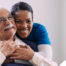 a graphic showing What a Week of Elder Care at Home Really Looks Like with a smiling caregiver and client