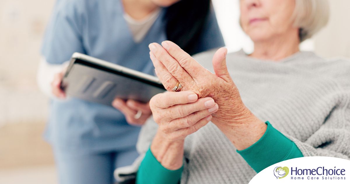 A caregiver provides in home care services to a senior with arthritis