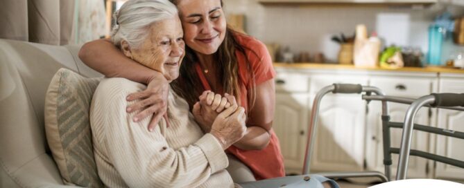 Caregiver supporting an elderly woman in the transition to senior home care