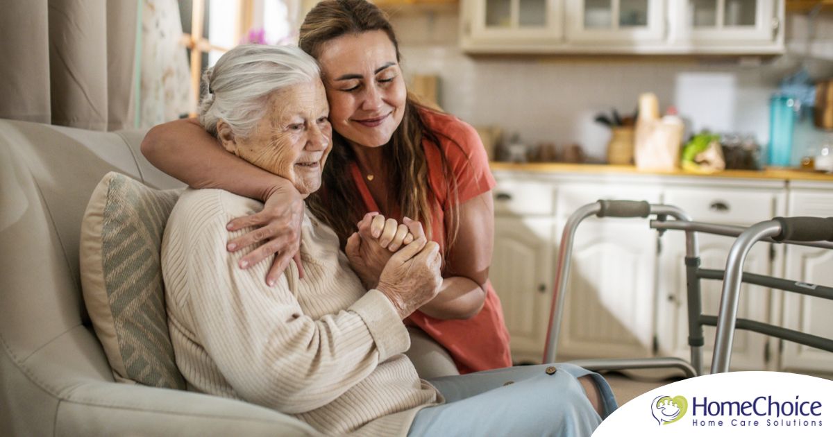 Caregiver supporting an elderly woman in the transition to senior home care