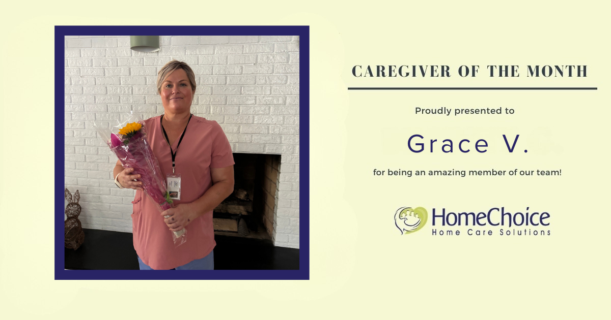 Graphic recognizing Grace V. as HomeChoice Home Care Solutions' June Caregiver of the Month. Grace is pictured smiling and holding a bouquet of flowers in front of a white brick fireplace. The graphic features the HomeChoice logo and the text, "Caregiver of the Month – Proudly presented to Grace V. for being an amazing member of our team!" in the company's signature blue and green brand colors.
