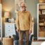 Exploring fall prevention for seniors — an elderly man stands in a safely arranged room.