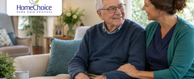 Home caregiver talking with an older man in a bright living room while providing supportive Parkinson’s home care.