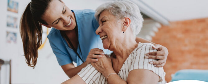 A female caregiver helping an older woman with stroke recovery at home.