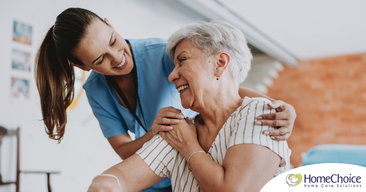 A female caregiver helping an older woman with stroke recovery at home.