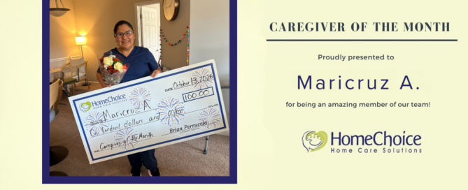 Maricruz A., HomeChoice Home Care Solutions’ October 2026 Caregiver of the Month, smiles while holding flowers and her Caregiver of the Month award check.