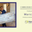 Maricruz A., HomeChoice Home Care Solutions’ October 2026 Caregiver of the Month, smiles while holding flowers and her Caregiver of the Month award check.