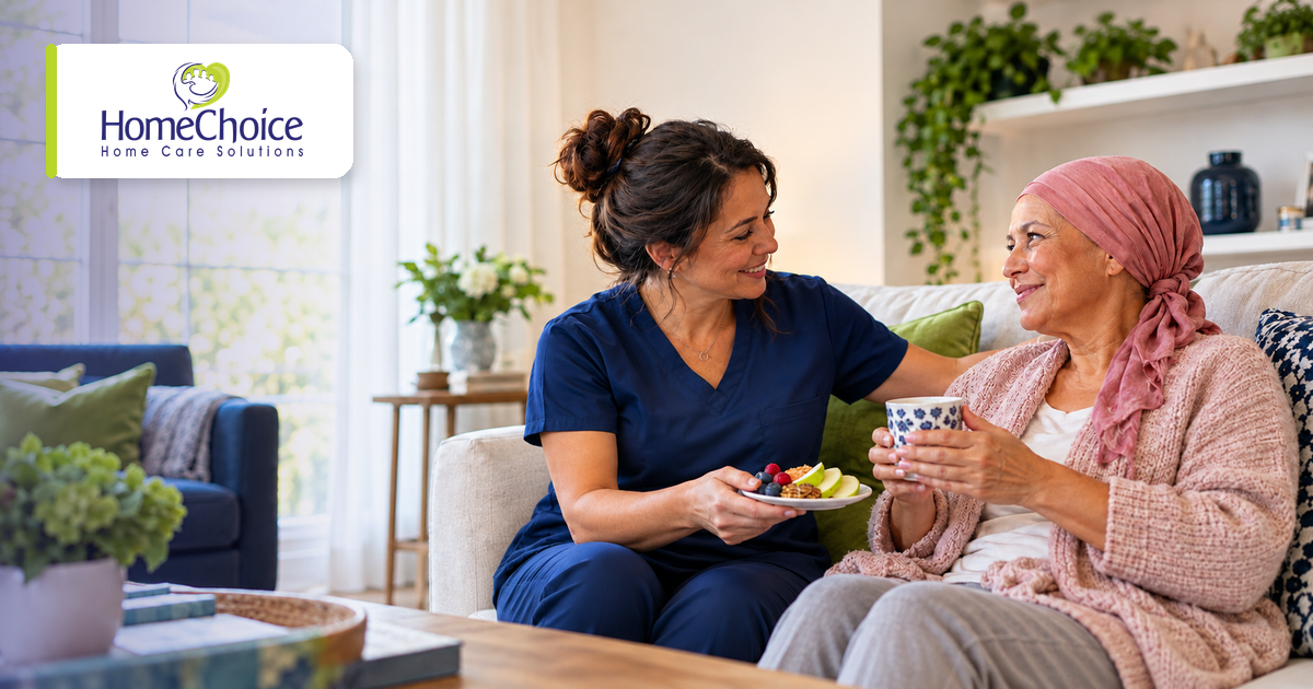 HomeChoice caregiver in navy scrubs sharing a healthy snack with a woman recovering from breast cancer at home with home care support.