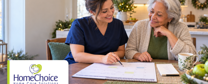 Caregiver in navy scrubs and an older woman smiling together while reviewing a calendar and planning for the holidays at home. The HomeChoice Home Care Solutions logo appears in the lower-left corner.