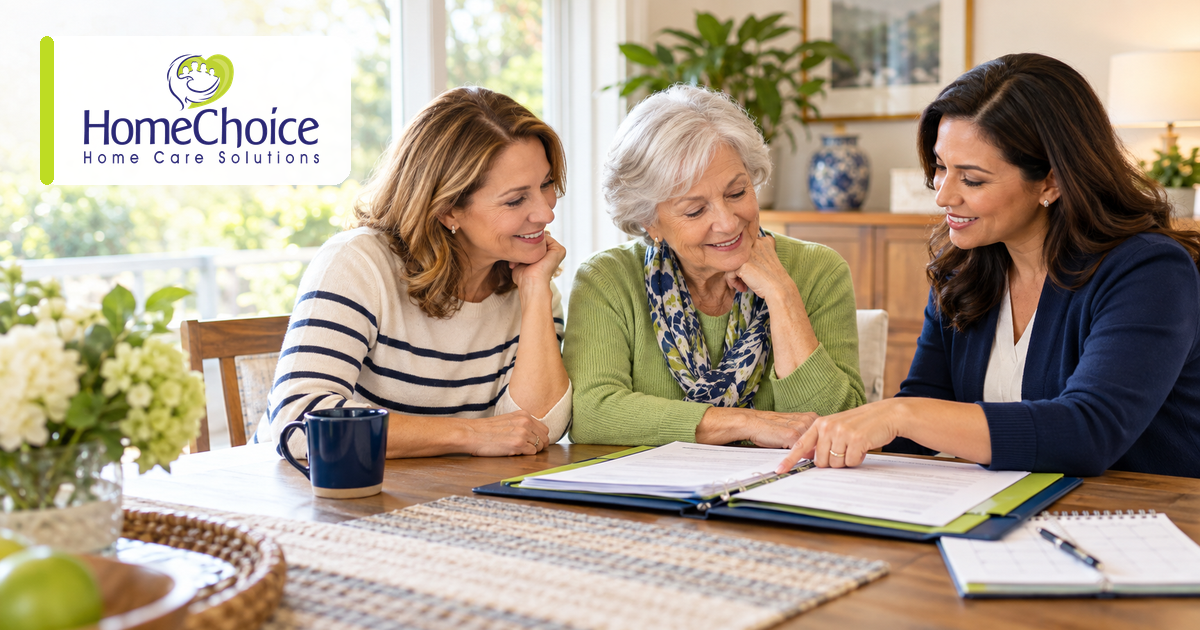An older woman and her adult daughter review long term care insurance paperwork with a HomeChoice care professional at a table in their home.